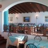 Sala ristorante elegante con tavoli apparecchiati e sedie nere.