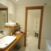 Un bagno moderno con lavandino, specchio e accappatoi.