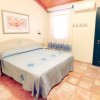 Camera con letto matrimoniale, decorazioni blu e porta verde.