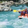 Gruppo fa rafting in un fiume turbolento.