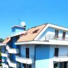 Edificio a più piani con balconi, cielo limpido.