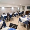 Sala da pranzo con tavoli apparecchiati.