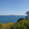 Un camper vicino al mare con panorama di isole in lontananza.