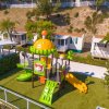 Parco giochi colorato con scivolo giallo.