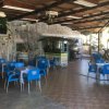 Sala esterna con tavoli e sedie blu.