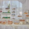 Esposizione di dolci e snack su tavolo bianco.