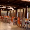 Interno di un ristorante con sedie arancioni e bianche.