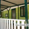 Veranda di casa mobile verde con tettoia.