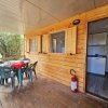 Veranda in legno con tavolo e sedie.