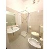 Bagno con doccia, lavabo, bidet e WC. Rivestimento chiaro.