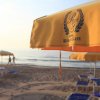 Spiaggia con ombrellone giallo e logo 